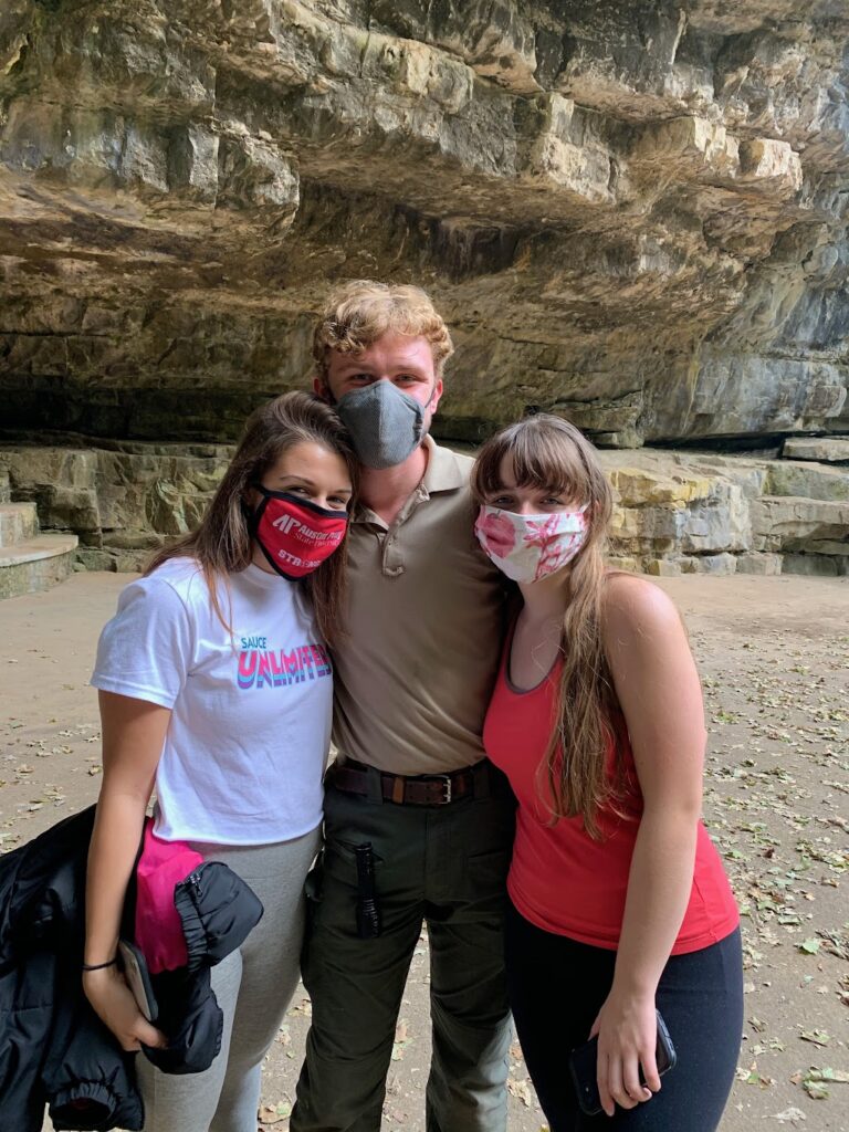 Me and two of my friends taking a picture together with masks on at Dunbar Cave State Park